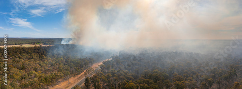 Aerial panorama of plumes of brown bushfire smoke rising from bushland photo