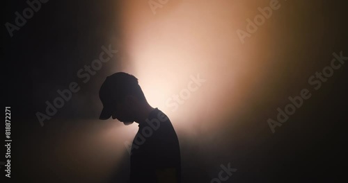 Silhouette of a man in a baseball cap
