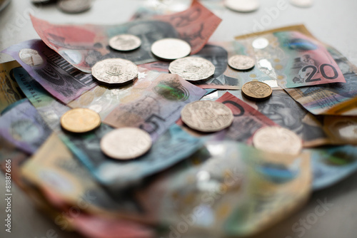 assorted Australian currency including notes and coins on a benchtop photo