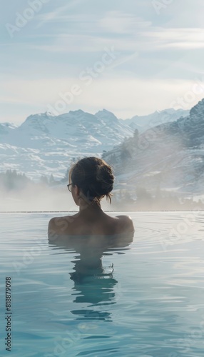 Escape and Relaxation  Woman in Thermal Spa Pool with Snowy Mountain Background