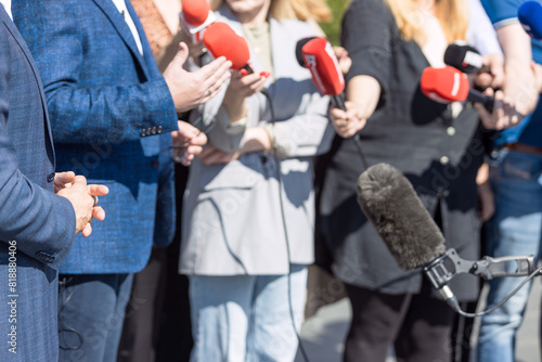 Group of journalists and news reporters holding microphones. Public relations - PR.