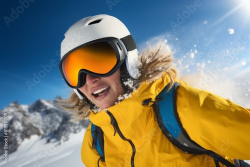 a happy woman wearing a helmet and yellow anorak and ski goggles and skies skiing down a slope on a winter day. 