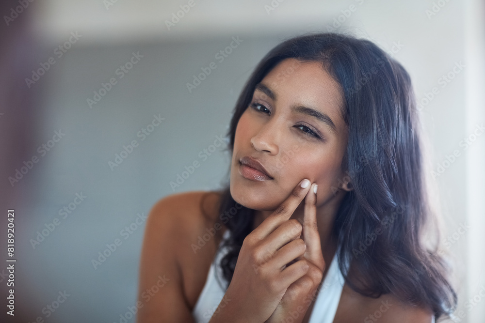 Skincare, woman and face and acne with mirror reflection in bathroom for grooming and morning routine. Indian, female person and dermatology with hand for popping pimple or blackhead for breakout Skincare, woman and face and acne with mirror reflection in bathroom for grooming and morning routine. Indian, female person and dermatology with hand for popping pimple or blackhead for breakout