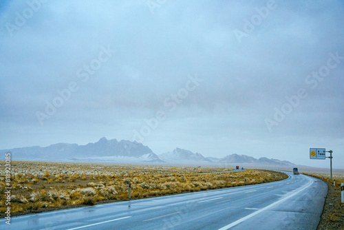 Haixi Mongolian and Tibetan Autonomous Prefecture, Qinghai Province - grasslands and roads under snow-capped mountains