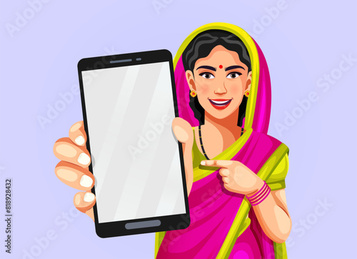 Portrait of a happy traditional Indian woman wearing a saree raising her hand to show a smartphone with an empty display to put an advertisement