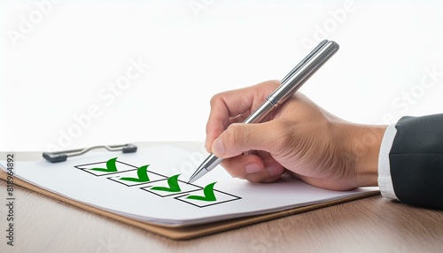 close up a hand mand with pen writing on paper with check mark icon isolated white background photo