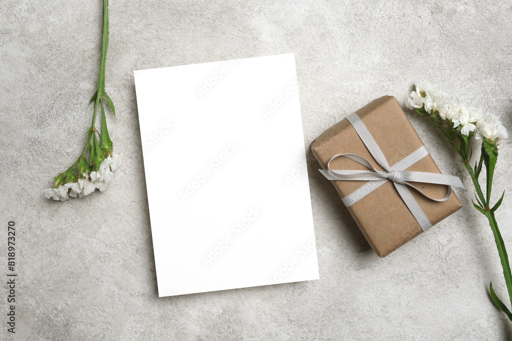 Blank greeting card mockup with gift box and flowers, empty card mock up with copy space Blank greeting card mockup with gift box and flowers, empty card mock up with copy space