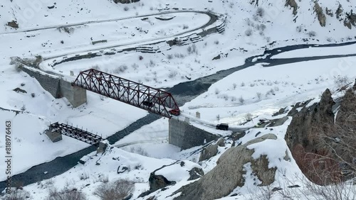 13 Feb 2024- Vehicles navigating on Bridge over Spiti River and Snowy Landscape. photo