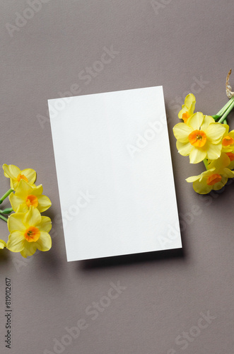 Blank greeting or invitation card mockup with daffodils flowers, copy space