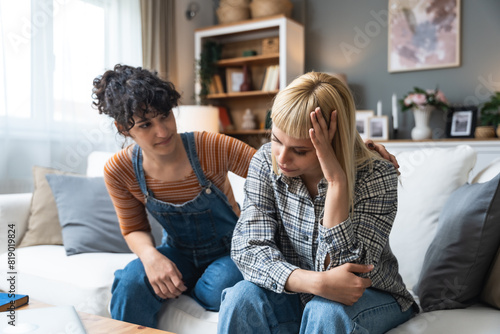 Фотография Young lesbian couple having relationship difficulties and arguing at home