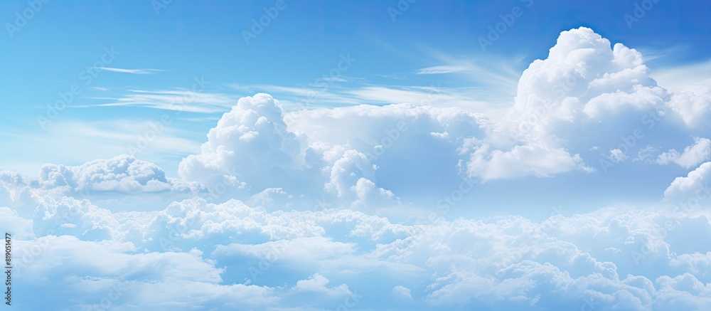 The blue sky is adorned with white veil clouds providing a beautiful and serene copy space image