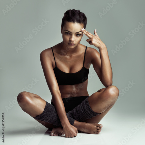 Exercise, mindset and pointing with portrait of woman in studio isolated on gray background. Fitness, hand gesture and workout with serious athlete sitting at gym for challenge, health or performance