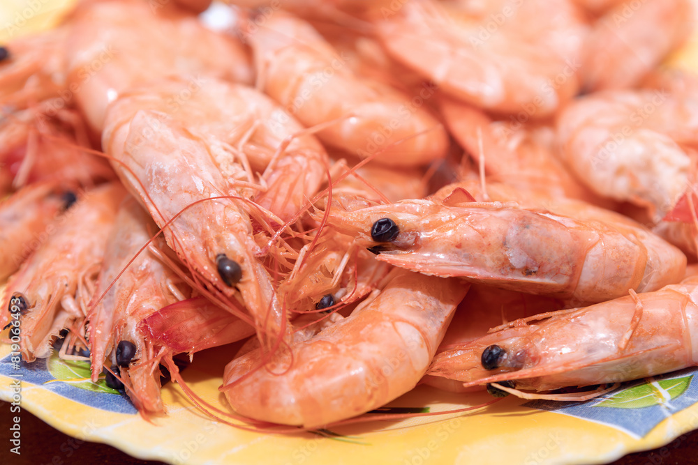 Cooked shrimps in a table. Typically marine frequently harvested for food Cooked shrimps in a table. Typically marine frequently harvested for food