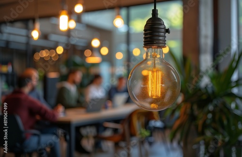 Group of People Sitting Around Table With Light Bulb in Background