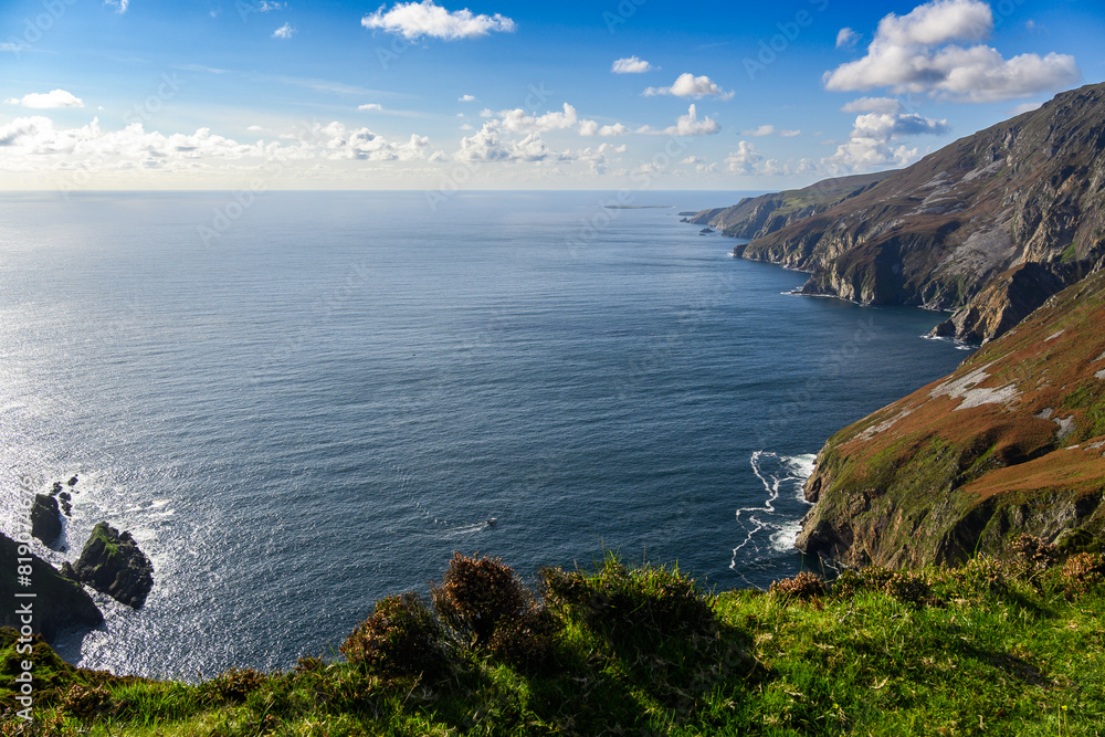 Fototapeta premium Calm Lake Beside Lush Green Hillside