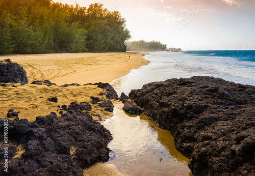 The Remaining Wall of an Ancient Lava Flow Guard One End of Kahalahala Beach, Kauai, Hawaii, USA photo