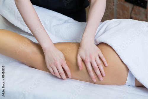 Close-up of a young woman having a leg massage in a spa. Beauty treatment concept.