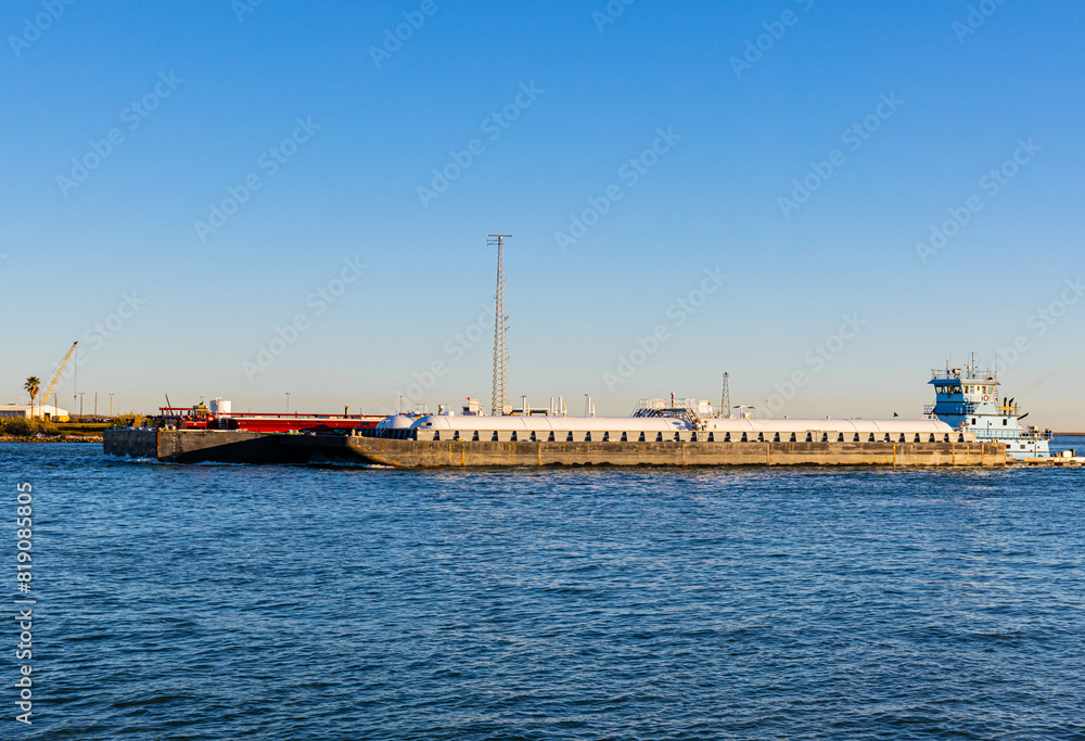 Tug Boat Pushing Barges Through The Intercoastal Waterway, Roberts Point Park, Port Aransas, Texas, USA