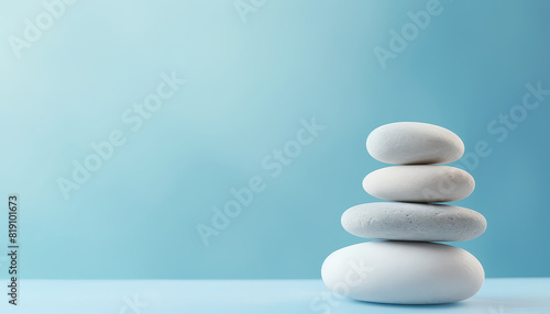 Balancing white stones on blue background