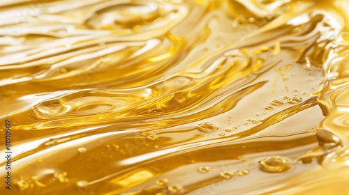 Golden liquid, with smooth, flowing texture and glistening surface, resembling honey or syrup, evoking richness and warmth.