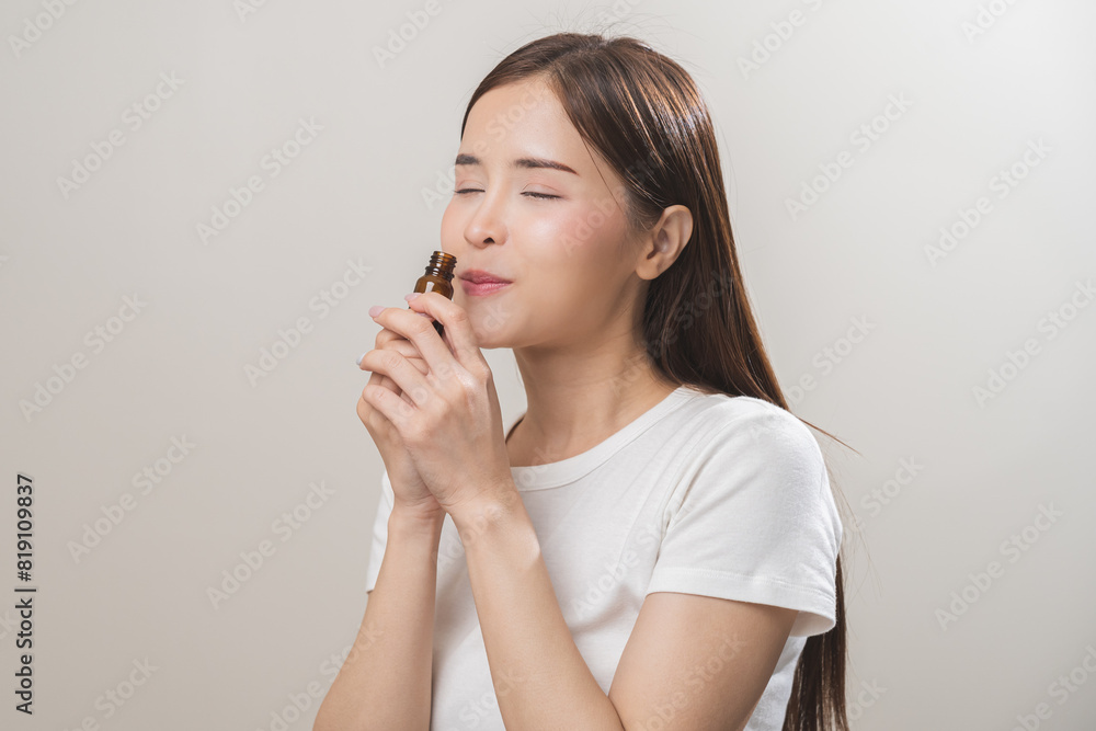 Aromatherapy, pretty asian young woman close her eyes enjoying smell fragrance of herbal from medicine natural organic essential perfume oil.Therapy treatment, beauty skin care isolated on background Aromatherapy, pretty asian young woman close her eyes enjoying smell fragrance of herbal from medicine natural organic essential perfume oil.Therapy treatment, beauty skin care isolated on background