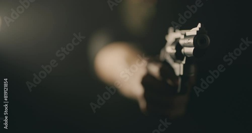 Masked man aiming a revolver