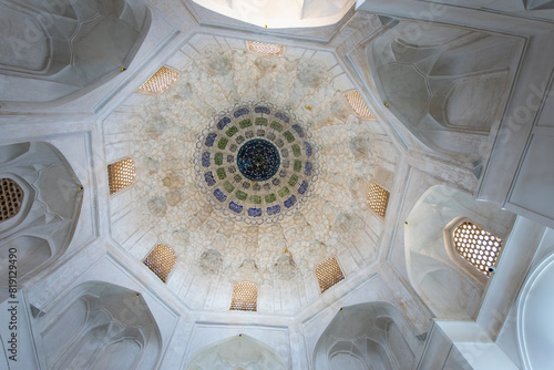 Architectural detail of the ceiling of Agha Bozog Mosque with geometric patterns and light-filtering windows. Capturing traditional Islamic art, Tehran, Iran. photo