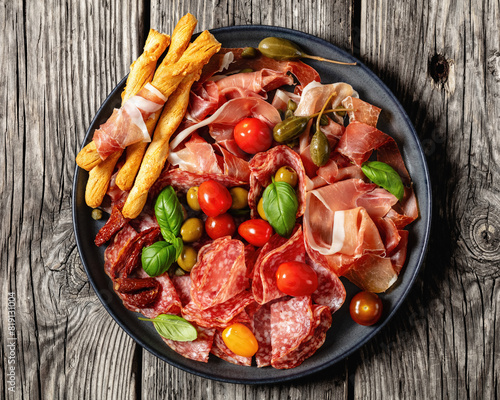 italian antipasto plate of cured meat and veggies photo