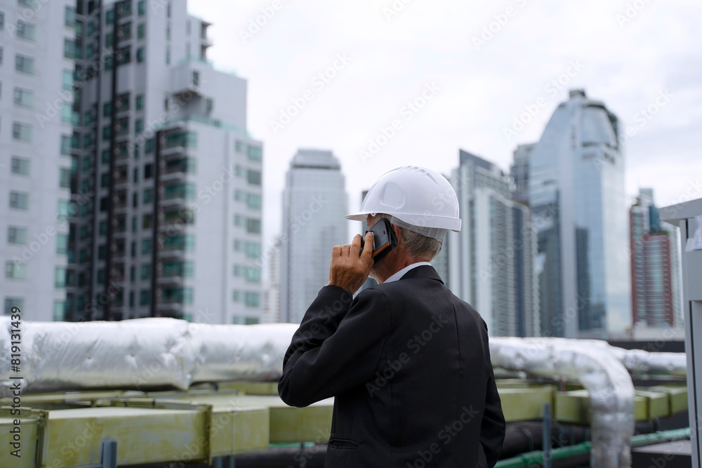 Engineer is working on the rooftop of high rise building. Engineer is working on the rooftop of high rise building.