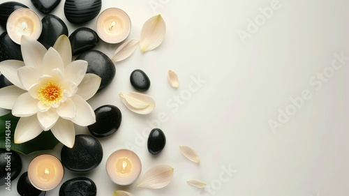 White background on the theme of Thai massage with copy space. Lotus flower  black stones and candles. Top view