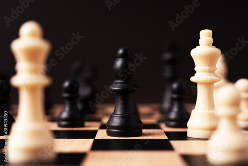Black bishop chess surround by other chess black background photo