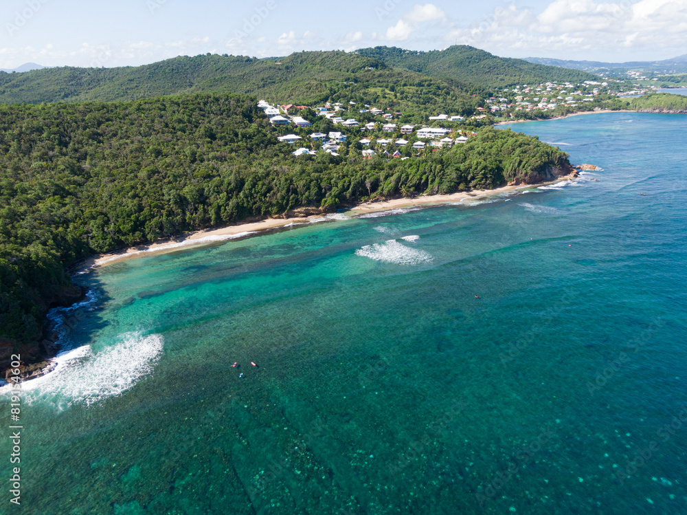 Aerial view of Tartane's famous surf spot with surfers in the Water, Martinique, West Indies, France