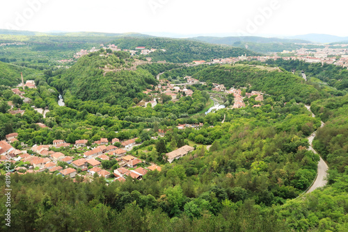 Picturesque view from the hiking trail along the Garga Bair Hill over the city of Veliko Tarnovo and the dense, lush forest that surrounds it, Veliko Tarnovo, Bulgaria photo