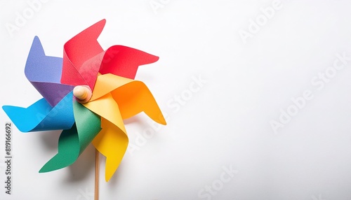pinwheel or windmill paper origami isolated on white background simple starter craft for kids for weekend entertainment. ESG and Clean Energy Concept. Wind Turbine Paper into the Sky. Decrease Carbon
