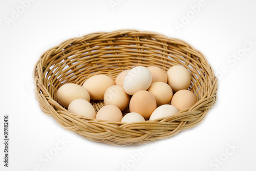 Organic chicken eggs in a bamboo basket on a white background are eggs that come from chickens raised on organic food. They do not contain toxic residues that are harmful to the body.