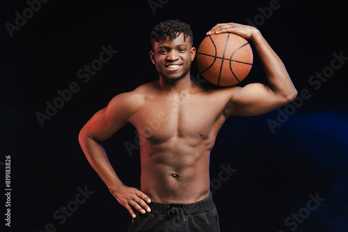 Happy handsome African American man with bare torso, muscular body holding basketball © Maria Vitkovska