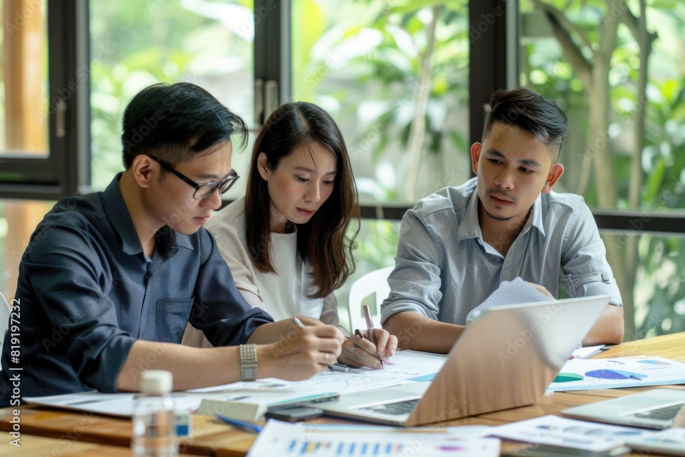 A group of people sitting around a wooden table. Suitable for business and teamwork concepts A group of people sitting around a wooden table. Suitable for business and teamwork concepts
