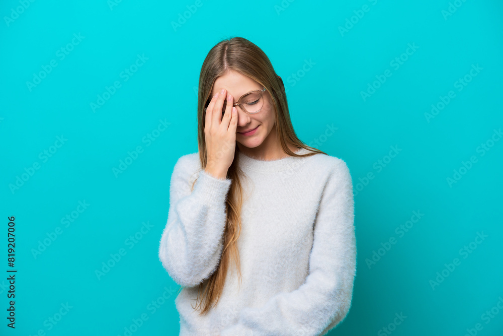 Young Russian woman isolated on blue background with headache Young Russian woman isolated on blue background with headache