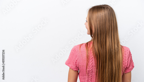 Young Russian woman isolated on white background in back position and looking side