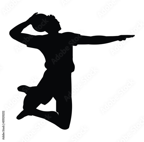 Silhouette of a of a high-jumping volleyball player in profile who aims and throws the ball forward