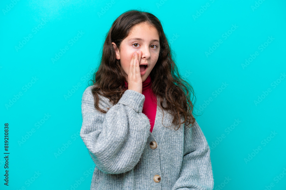Little girl isolated on blue background with surprise and shocked facial expression Little girl isolated on blue background with surprise and shocked facial expression