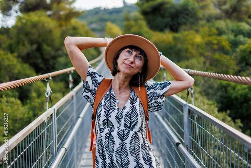 happy girl travels. young woman in a hat and with a backpack enjoys traveling.