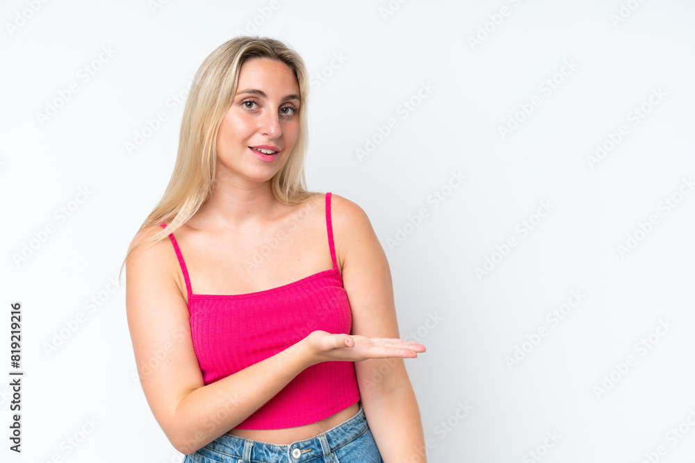 Young caucasian woman isolated on white background presenting an idea while looking smiling towards Young caucasian woman isolated on white background presenting an idea while looking smiling towards