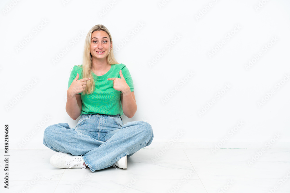 Young caucasian woman sitting on the floor isolated on white background with surprise facial expression Young caucasian woman sitting on the floor isolated on white background with surprise facial expression