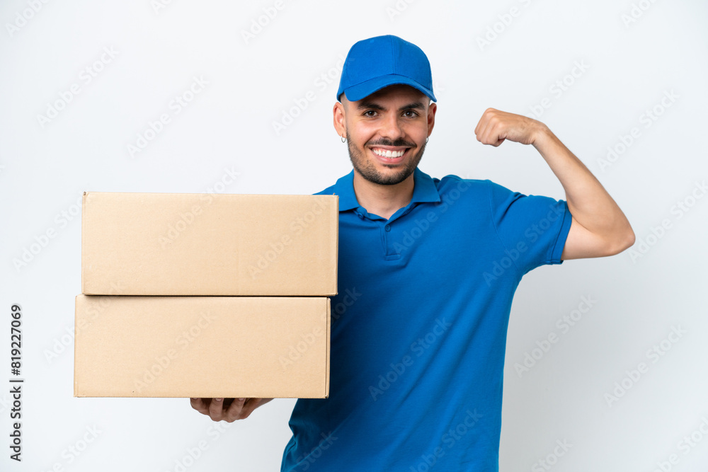 Delivery caucasian man isolated on white background doing strong gesture