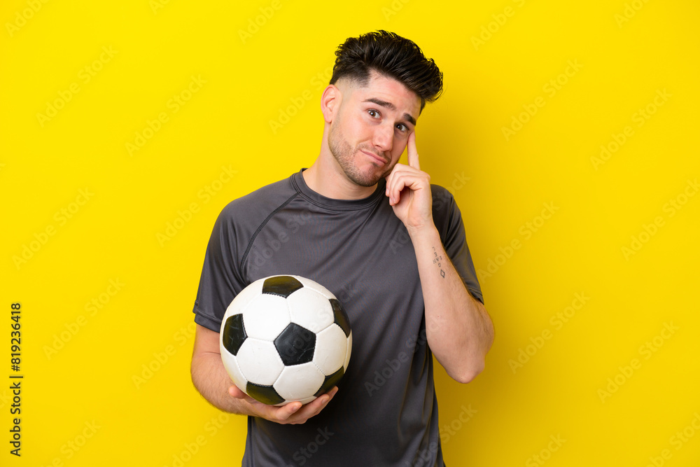 Handsome young football player man isolated on yellow background thinking an idea Handsome young football player man isolated on yellow background thinking an idea