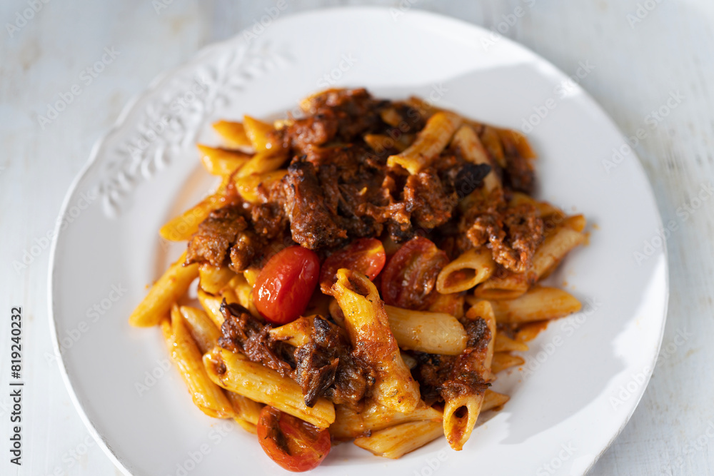 italian penne pasta in oxtail bolognese sauce