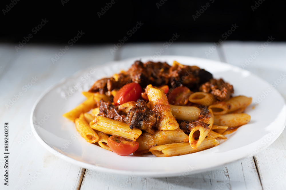 italian penne pasta in oxtail bolognese sauce