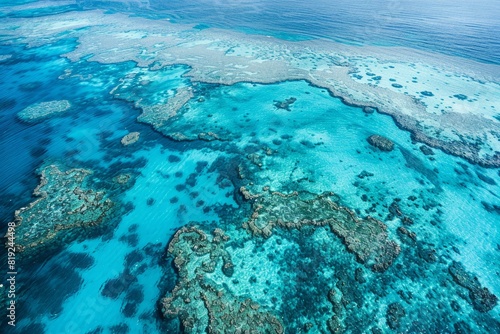 A vast expanse of coral atolls spread across turquoise waters in the Great Barrier Reef