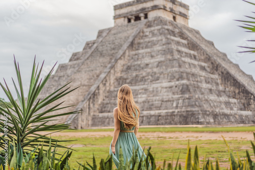 Beautiful tourist woman observing the old pyramid and temple of the castle of the Mayan architecture known as Chichen Itza these are the ruins of this ancient pre-columbian civilization and part of